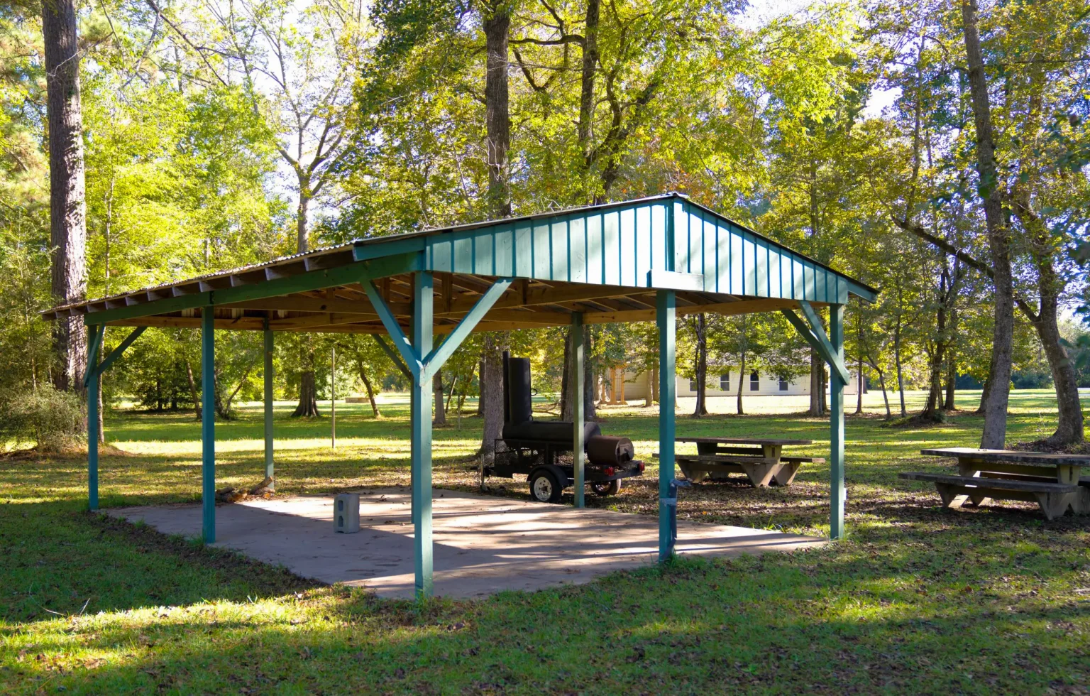 Covered BBQ area with picnic tables at Twin Lakes